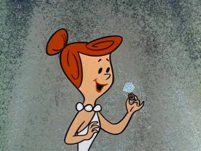 Wilma Flintstone looking at a diamond ring; How to get engaged