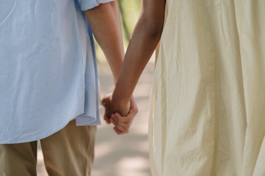 Couple holding hands - photo by Ron Lach